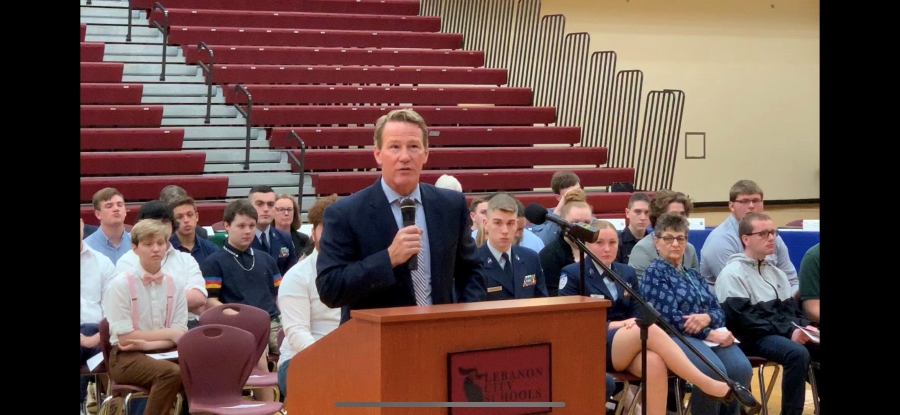 man speaking at a podium